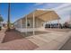 Exterior of home featuring a covered driveway and neutral color scheme at 320 E Mckellips Rd # 50, Mesa, AZ 85201