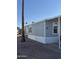 Side view of gray manufactured home with desert landscaping at 320 E Mckellips Rd # 50, Mesa, AZ 85201