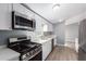 Close-up of updated kitchen appliances and white cabinetry for storage and cooking at 320 E Mckellips Rd # 50, Mesa, AZ 85201