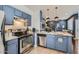 Well-equipped kitchen with modern stainless appliances, ample counter space and blue cabinets at 3302 N 7Th St # 249, Phoenix, AZ 85014