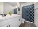 Bathroom featuring a shower with blue shower curtain, a gray tiled floor, and ample counter space at 3320 E Tina Dr, Phoenix, AZ 85050