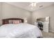 Bedroom featuring a dark wood bed frame, vanity area, plush bedding and neutral walls at 3320 E Tina Dr, Phoenix, AZ 85050