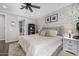 Comfortable bedroom with a brick wall, a ceiling fan, and ample natural light from the large window at 3320 E Tina Dr, Phoenix, AZ 85050