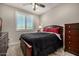 Bedroom featuring a dark wood bed frame, dresser, plush bedding and neutral walls at 3320 E Tina Dr, Phoenix, AZ 85050