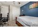 Bedroom featuring a full bed, closet, blue accent wall, and natural light at 3320 E Tina Dr, Phoenix, AZ 85050