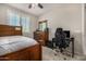 Bedroom featuring a dark wood bed frame, gaming chair, desk and neutral walls at 3320 E Tina Dr, Phoenix, AZ 85050