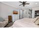 Bright bedroom featuring a ceiling fan, white dresser with a TV, and an ensuite bathroom at 3320 E Tina Dr, Phoenix, AZ 85050