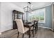 Elegant dining room features a modern chandelier, stylish chairs, and a window with natural light at 3320 E Tina Dr, Phoenix, AZ 85050