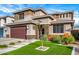 Beautiful two-story home featuring a well-manicured front yard with lawn and desert landscaping at 3320 E Tina Dr, Phoenix, AZ 85050