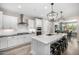 Bright white kitchen with stainless appliances, subway tile backsplash, and an island with seating at 3320 E Tina Dr, Phoenix, AZ 85050