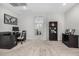 Neutral toned office area featuring a built-in desk, cabinets and adjacent staircase at 3320 E Tina Dr, Phoenix, AZ 85050