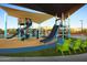 Community playground featuring slides, climbing structures and shaded seating areas for children at 3320 E Tina Dr, Phoenix, AZ 85050