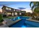 Evening view of a private backyard pool with lighting, seating area, and a spa at 3320 E Tina Dr, Phoenix, AZ 85050