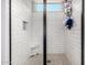 Modern shower stall with white subway tile, glass door, and tiled floor, providing a sleek design at 3320 E Tina Dr, Phoenix, AZ 85050