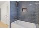 Bathroom with blue hexagon tile and a bathtub at 37020 N 31St Ave, Phoenix, AZ 85086