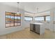 Modern kitchen with white cabinets, a large island, and expansive windows showcasing scenic views at 37020 N 31St Ave, Phoenix, AZ 85086