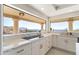 Modern kitchen with white cabinets, marble countertops, and stunning mountain views at 37020 N 31St Ave, Phoenix, AZ 85086