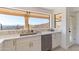 Clean kitchen boasts marble countertops, stainless steel appliances, and a lovely view at 37020 N 31St Ave, Phoenix, AZ 85086