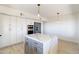 Modern kitchen with white cabinets, marble island, and stainless steel appliances at 37020 N 31St Ave, Phoenix, AZ 85086