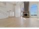 Spacious living room featuring high ceilings, a stone fireplace, and large windows with scenic views at 37020 N 31St Ave, Phoenix, AZ 85086