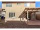 Exterior view of the backyard patio with a pergola, desert landscaping, and stucco exterior at 3801 E Kent Dr, Phoenix, AZ 85044