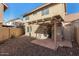 Private backyard featuring a covered patio, gravel landscaping, and views of the house's rear facade at 3801 E Kent Dr, Phoenix, AZ 85044