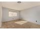 Neutral bedroom with carpet, a window with bright natural light, and electric outlets at 3801 E Kent Dr, Phoenix, AZ 85044