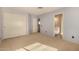 Spacious bedroom with a closet and a view to a bathroom, featuring neutral carpet at 3801 E Kent Dr, Phoenix, AZ 85044