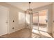 Bright dining area with sliding glass door, tile flooring, and modern light fixture creates an inviting space at 3801 E Kent Dr, Phoenix, AZ 85044