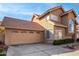 Charming two-story home featuring a red tile roof, arched window, desert landscaping, and two-car garage at 3801 E Kent Dr, Phoenix, AZ 85044