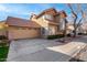 Charming two-story home featuring a red tile roof, arched window, desert landscaping, and two-car garage at 3801 E Kent Dr, Phoenix, AZ 85044