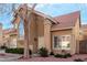 Charming two-story home featuring a red tile roof, arched window, desert landscaping, and covered front entry at 3801 E Kent Dr, Phoenix, AZ 85044