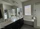 Bathroom with double vanity and soaking tub at 41262 W Almira Dr, Maricopa, AZ 85138