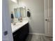 Modern bathroom with dark vanity, white countertop, and tile floor at 41262 W Almira Dr, Maricopa, AZ 85138