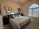 King size bed in spacious bedroom with large window at 41262 W Almira Dr, Maricopa, AZ 85138