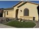 Tan colored house with a two-car garage and nicely landscaped yard at 41262 W Almira Dr, Maricopa, AZ 85138