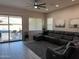 Living room with sectional sofa and view of pool at 41262 W Almira Dr, Maricopa, AZ 85138