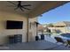 Covered patio with TV, wet bar, and pool view at 41262 W Almira Dr, Maricopa, AZ 85138