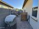 Side yard with a covered grill and storage area at 41262 W Almira Dr, Maricopa, AZ 85138