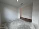 Bright bedroom featuring a closet with sliding doors, white walls, and concrete floors at 4328 E Bradford Ave, San Tan Valley, AZ 85140