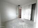 Bright bedroom featuring a closet with sliding doors and white walls and concrete floors at 4328 E Bradford Ave, San Tan Valley, AZ 85140