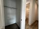 Walk-in closet with a view to the bathroom featuring tiled flooring and shelving at 4328 E Bradford Ave, San Tan Valley, AZ 85140