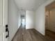 Bright entryway featuring wood flooring and white walls with door open to full bathroom at 4328 E Bradford Ave, San Tan Valley, AZ 85140