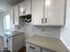 This kitchen features white cabinets, quartz counters and tile backsplash at 4328 E Bradford Ave, San Tan Valley, AZ 85140