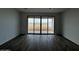 Bright living area with wood-look tile flooring features large sliding glass doors to backyard at 4328 E Bradford Ave, San Tan Valley, AZ 85140