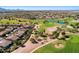 Expansive aerial view of homes surrounding a lush golf course with mature trees, water features, and sand traps at 4439 E Ficus Way, Gilbert, AZ 85298