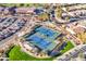 An aerial view showcasing tennis and bocce ball courts as well as lush landscaping and mature trees at 4439 E Ficus Way, Gilbert, AZ 85298