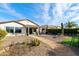 Landscaped backyard with covered patio offers an ideal outdoor living and entertaining space at 4439 E Ficus Way, Gilbert, AZ 85298