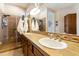 Bathroom featuring a glass-enclosed shower and double sinks with tile countertop at 4439 E Ficus Way, Gilbert, AZ 85298