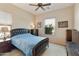 Bedroom with plush carpeting, ceiling fan, and large windows at 4439 E Ficus Way, Gilbert, AZ 85298